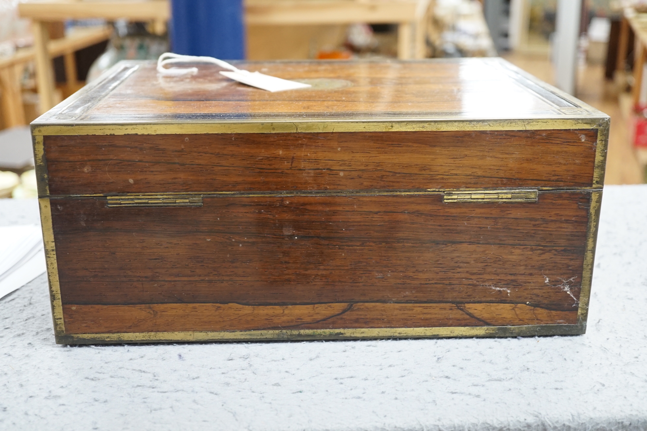 A George IV brass mounted rosewood travelling toilet box, with eleven silver mounted glass toilet jars etc, John & Archibald Douglas, London, 1822, with engraved monograms, four caps unmarked, box 34.1cm.